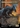 Grim Giganotosaurus (Borderless) (Emblem) (Borderless) (Foil) - Jurassic World Collection